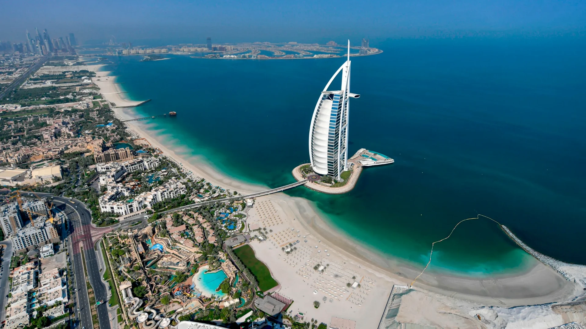 Aerial view of the Dubai coastline with the Burj Al Arab and turquoise sea