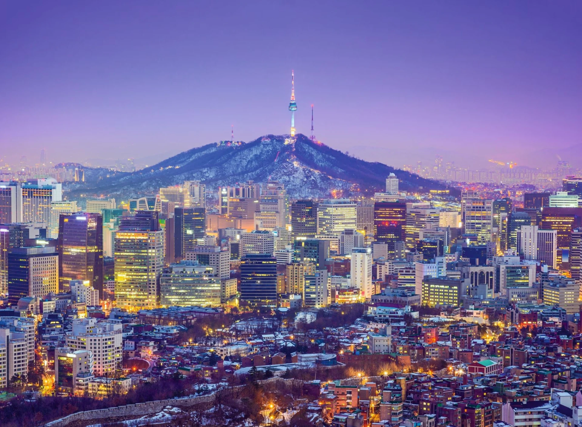 Seoul skyline at dusk with Namsan tower on a snowy mountain